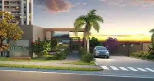 Entrada de condomínio Florae Vitta Residencial, com portão, carro estacionado, palmeira e paisagismo ao pôr do sol.